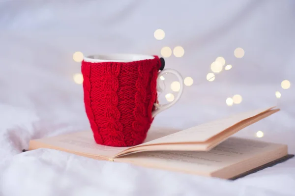 Knitted Cup Tea Staying Open Book Christmas Lights Background Close — Stock Photo, Image