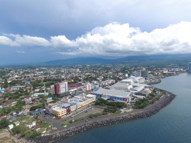 Manado, 20 Haziran 2020: güneşli bir günde Manado Endonezya 'nın mavi suları ve sahil otelleri ile gökdelenler marinası