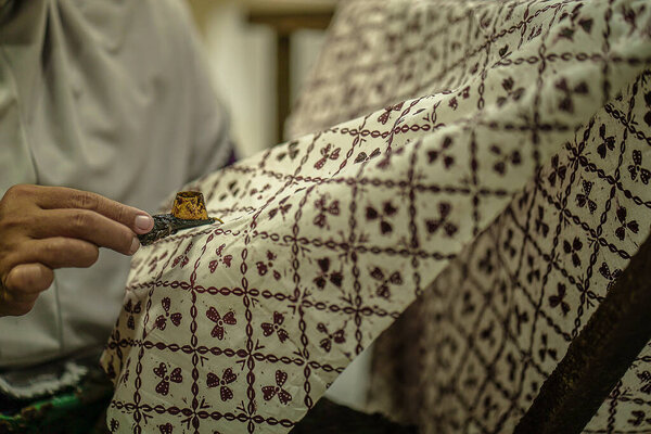 Surakarta, Indonesia - August, 7, 2020 : Canting batik background on the fabric. Drawing Batik Tulis