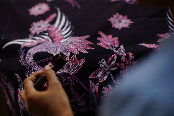 Surakarta, Indonesia - August, 7, 2020 : Canting batik background on the fabric. Drawing Batik Tulis