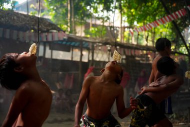 Endonezya 17 Ağustos 2020: Asyalı bir çocuğun Makan Kerupuk ile sahada eğlenirken portresi. Endonezya bağımsızlık günü konsepti