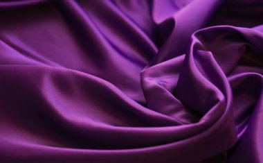 Mor parlak kumaş. Yumuşak, pürüzsüz kıvrımlarıyla sarmalanmış bir kumaş. Fabrika üretimi. Parlak doku.