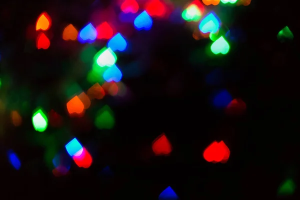 Bokeh Herzen Abstraktion Farbige Lichter Auf Schwarzem Hintergrund Feierlicher Hintergrund — Stockfoto