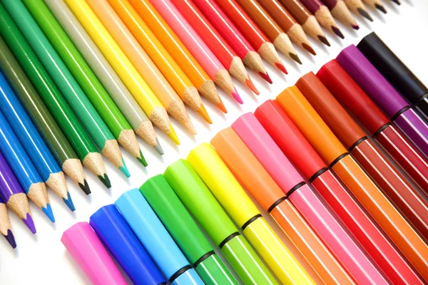 Sets of colored pencils and felt pens markers on white background close up view — Stock Photo, Image