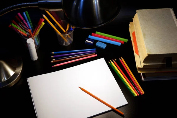 Back to school concept with empty sketchbook, colored pencils, table lamp, stationary supplies — Stock Photo, Image