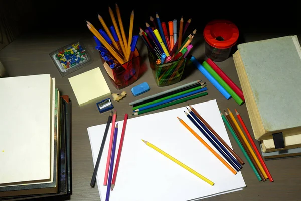 Back to school concept with empty sketchbook, colored pencils, stationary supplies and schoolbooks — Stock Photo, Image