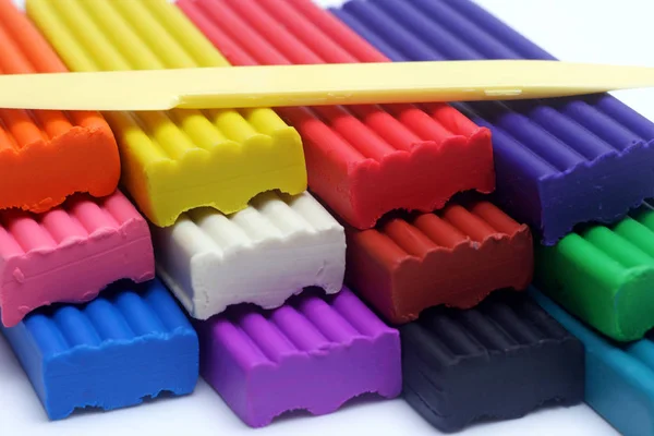 Multicolored set of plasticine sticks and sculptural knife on white background closeup view. — 스톡 사진