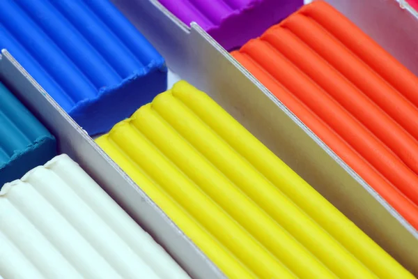 Blue, brown, white, yellow and orange plasticine sticks in cardboard box. — 스톡 사진