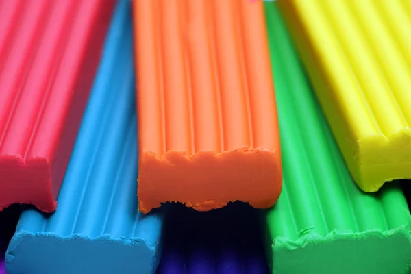 Red, blue,orange, green and yellow plastic clay sticks macro view, — 스톡 사진