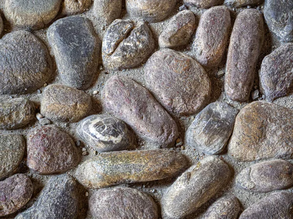 Steinhintergrund des alten Kopfsteinpflasters — Stockfoto