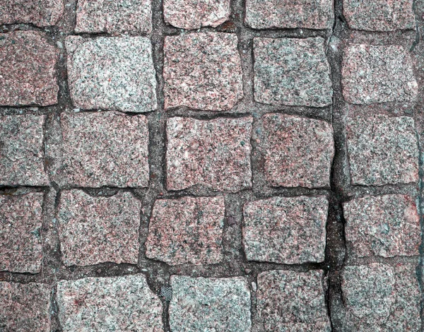 The stone pavement is paved with roughly processed red marble. — Stock Photo, Image