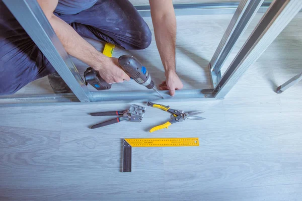 Male Builder Installs Metal Ceiling Profile Royalty Free Stock Images