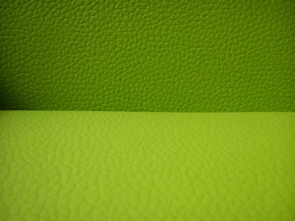 close-up of a sofa made of genuine pig leather, painted in two shades of green