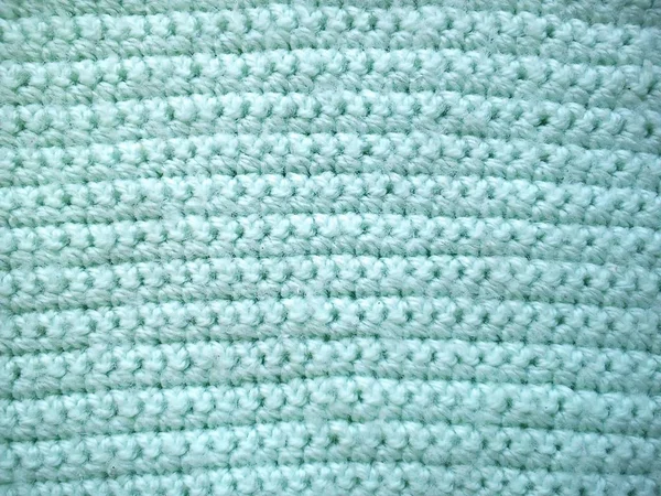 Primo piano di una maglia orizzontale di lana azzurra o verde — Foto Stock