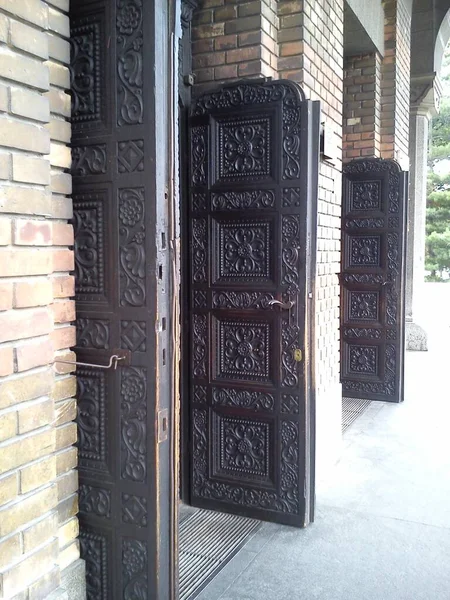 Open antieke houten deuren in een kerk. Massief eiken en deeltjeswanden — Stockfoto