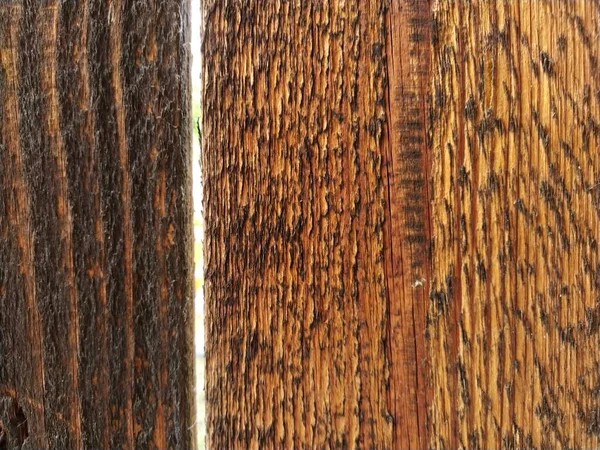 Wood texture. Dark wood species. Background from vertical boards. Mahogany wood, walnut. Grunge style.