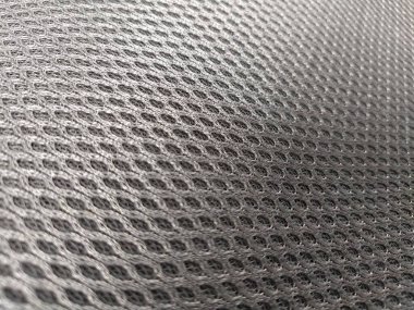 Soyut siyah naylon sentetik kumaş. Gri yapay örgü, kirliliğe dayanıklı. Çocuk arabası koltuğu parçası, yakın plan. Odaklanmamış fotoğraf