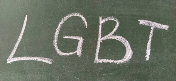 LGBT abbreviation written in white chalk on a green school board. Diversity of sexuality and gender identity based on culture. Designation of homosexual, bisexual and transgender people.