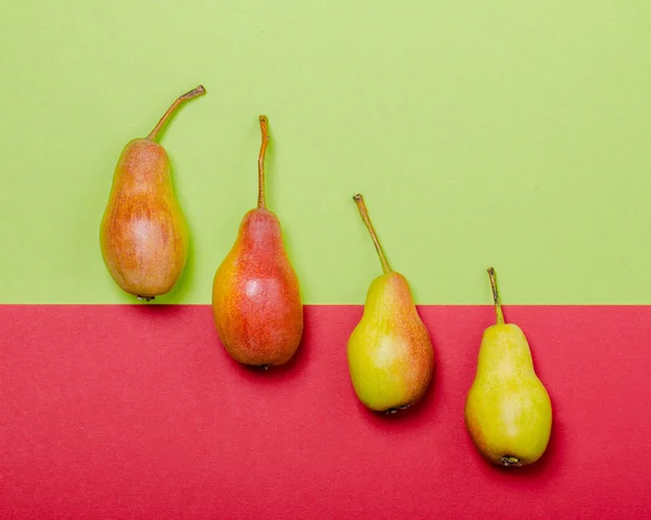 Green and red pears on green and red modern background