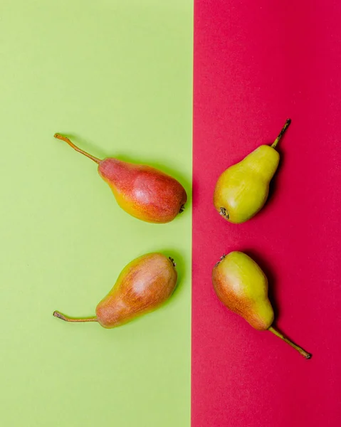 Green and red pears on green and red modern background