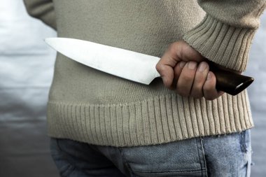 Kötü bir adam arkasında bir bıçak tutuyor, kurbanı bekliyor. Bir manyak ve silahlı bir tecavüzcü..