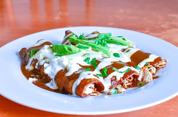 Delicious enchiladas of mole with cheese — Stock Image Delicious enchiladas of mole with cheese Stock Picture