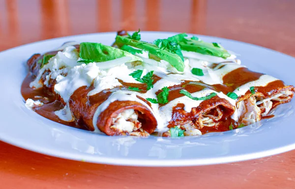 Delicious enchiladas of mole with cheese — Stock Photo, Image