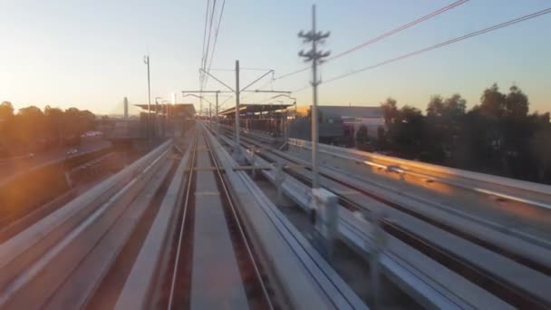 Der fahrerlose Zug nähert sich in der Nachmittagssonne einem erhöhten U-Bahn-Bahnsteig und blickt von innen in den vorderen Teil des Zuges. sydney australia. — Stockvideo