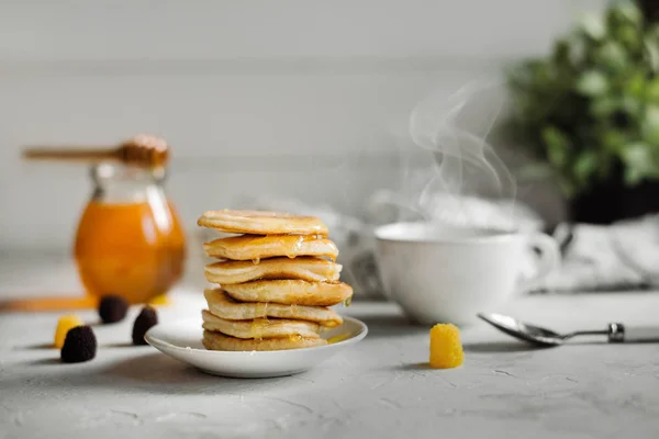Pancakes with honey and a Cup of tea Stock Picture