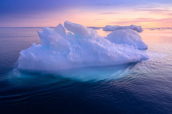 Floating glaciers in the rays of the setting sun at polar night Stock Photo