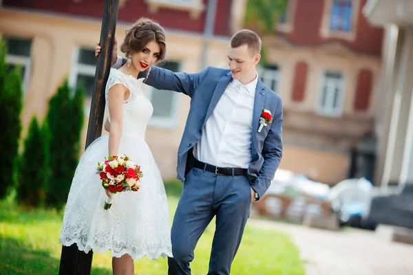 Elegantní nevěsta a ženich pózují spolu venku ve svatební den — Stock fotografie