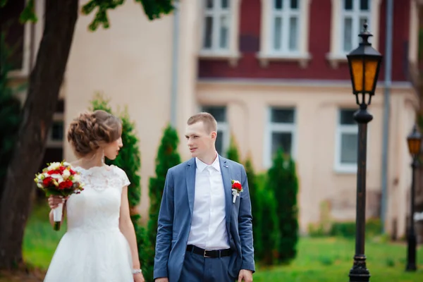 Bröllop. Unga par, nyligen gifta, håller varandra i handen — Stockfoto