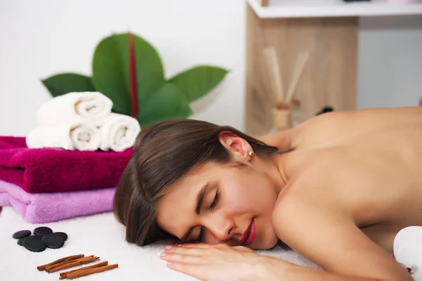 Giovane bella donna che riceve un trattamento termale nel salone di bellezza spa. Massaggio benessere. Salone di bellezza. — Foto Stock
