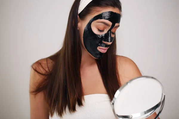 Beauty portrait woman skin care health black mask white background close up