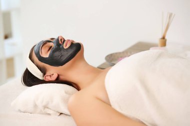 Yüz soyma maskesi, kaplıca güzellik tedavisi, cilt bakımı. Güzellik salonundaki kadın yüz bakımını alıyor. Yan görüş, yakın çekim.