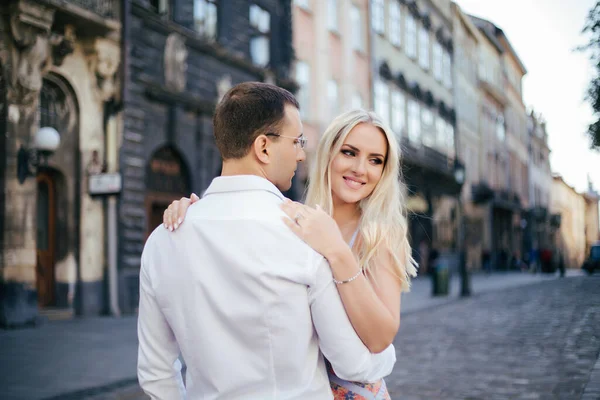 Junges verliebtes Paar umarmt sich vor Stadtkulisse — Stockfoto