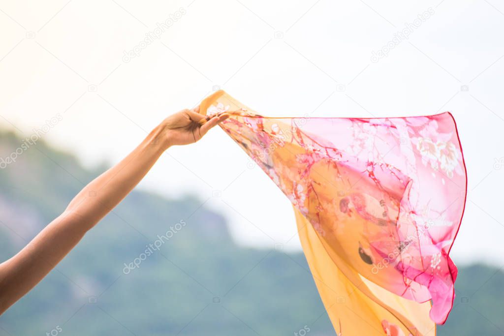 Beautiful young woman with flying scarf on beach,Carefree girl s