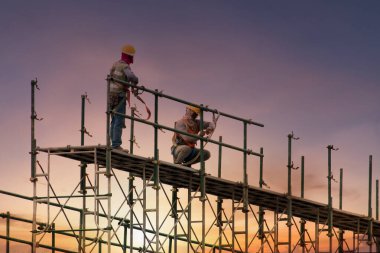 Man working on construction site with scaffold and building with clipart