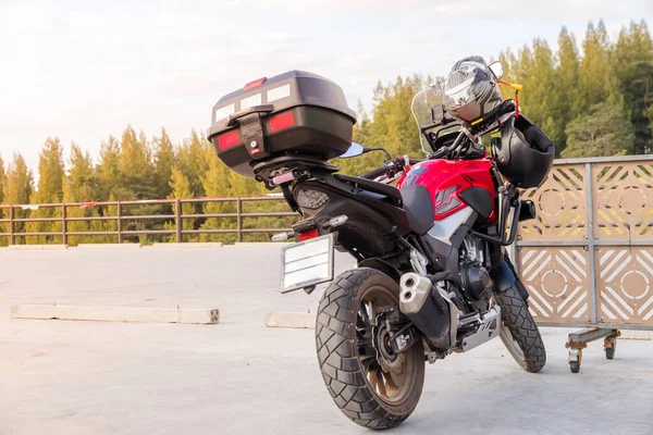 Motorcycle gloves and safety helmet hanging on a front seat of sport motorbike for safet