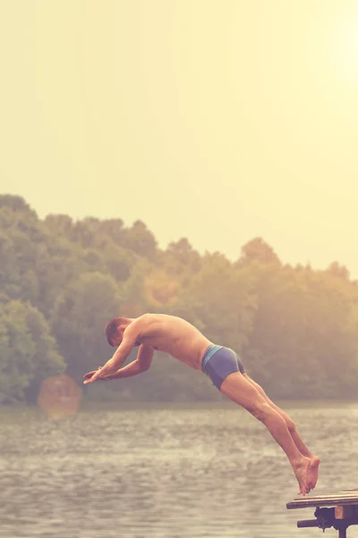 Man jumping in sea. Close up shot