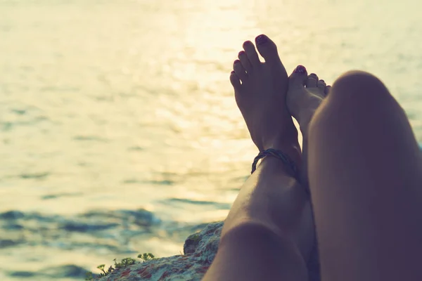 Girl\'s feet with ocean / sea tropical background