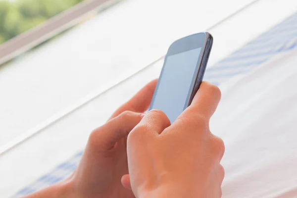 female hands swiping black screen of smartphone, close-up