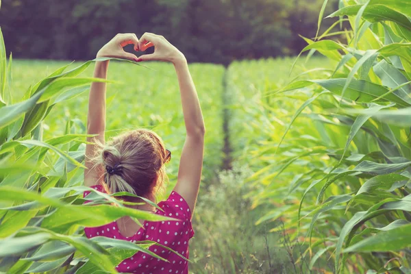 Back View Woman Raised Hands Showing Heart Sign While Standing — Stock Photo, Image