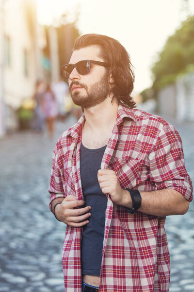 stylish man in sunglasses walking at street 