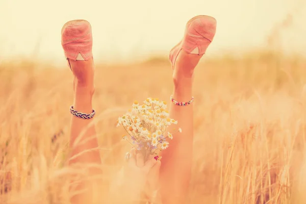 Woman Raising Legs Hands Bouquet Flowers While Lying Wheat Field — Stock Photo, Image