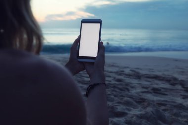 Tropikal egzotik kumsalda cep telefonu kullanan kız.