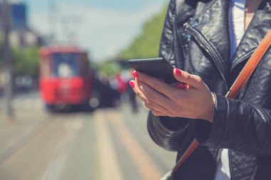 Smartphone açık havada, yakın görünümü kullanan genç kadın