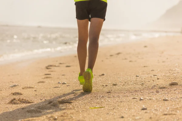 Jogging on a tropical sandy beach near sea / ocean.