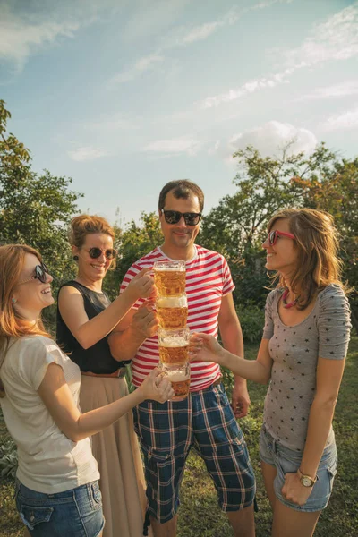 Several friends enjoying outdoors with the beer.