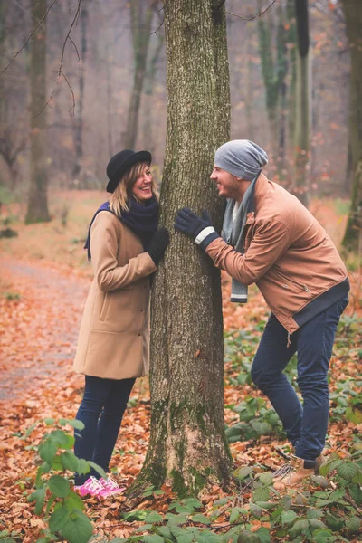 Cute couple in park filled with autumn colors.